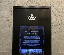 A digital screen embedded in an interior wall of the IBM Building. The title reads "Revitalizing an Icon". There is more text and images on the screen.